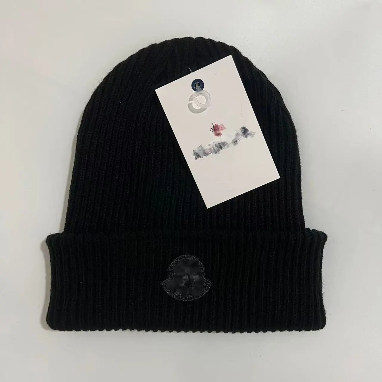 A knitted beanie inspired by Moncler's classic styles. - rep czapki